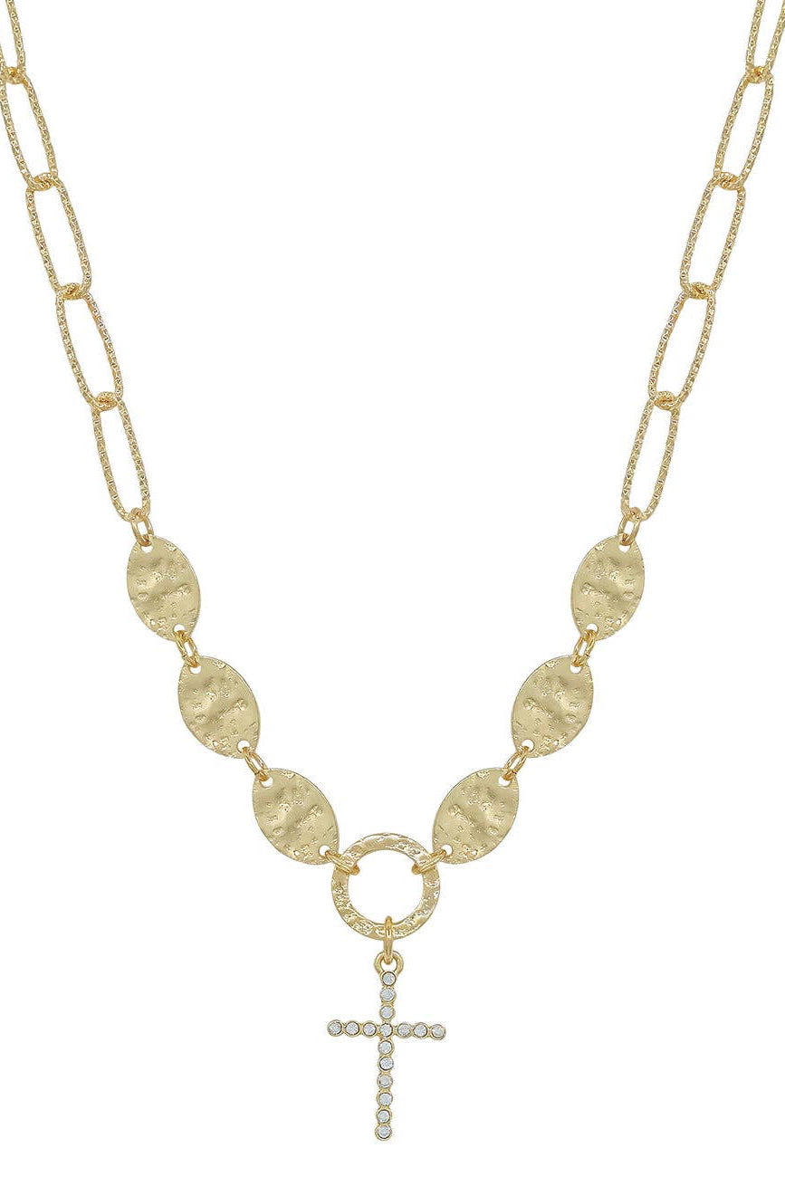 Gold necklace with circular links and a cross pendant on a white background