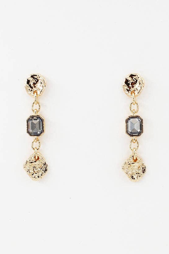 Gold earrings with gray gemstones on a white background